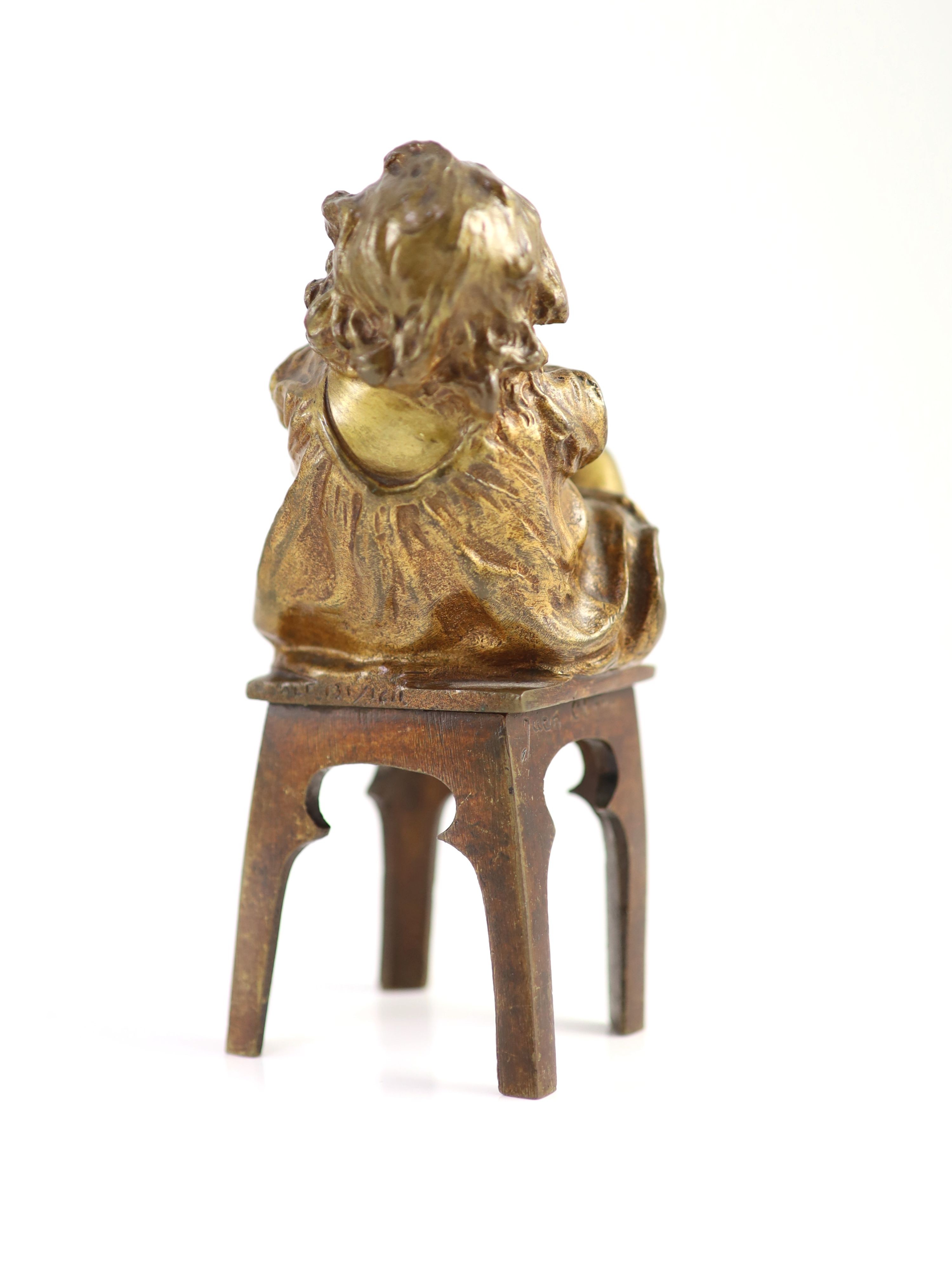 After Joan Clarà (1875 - 1958). A pair of bronze models of girls playing on chairs, height 15.5cm